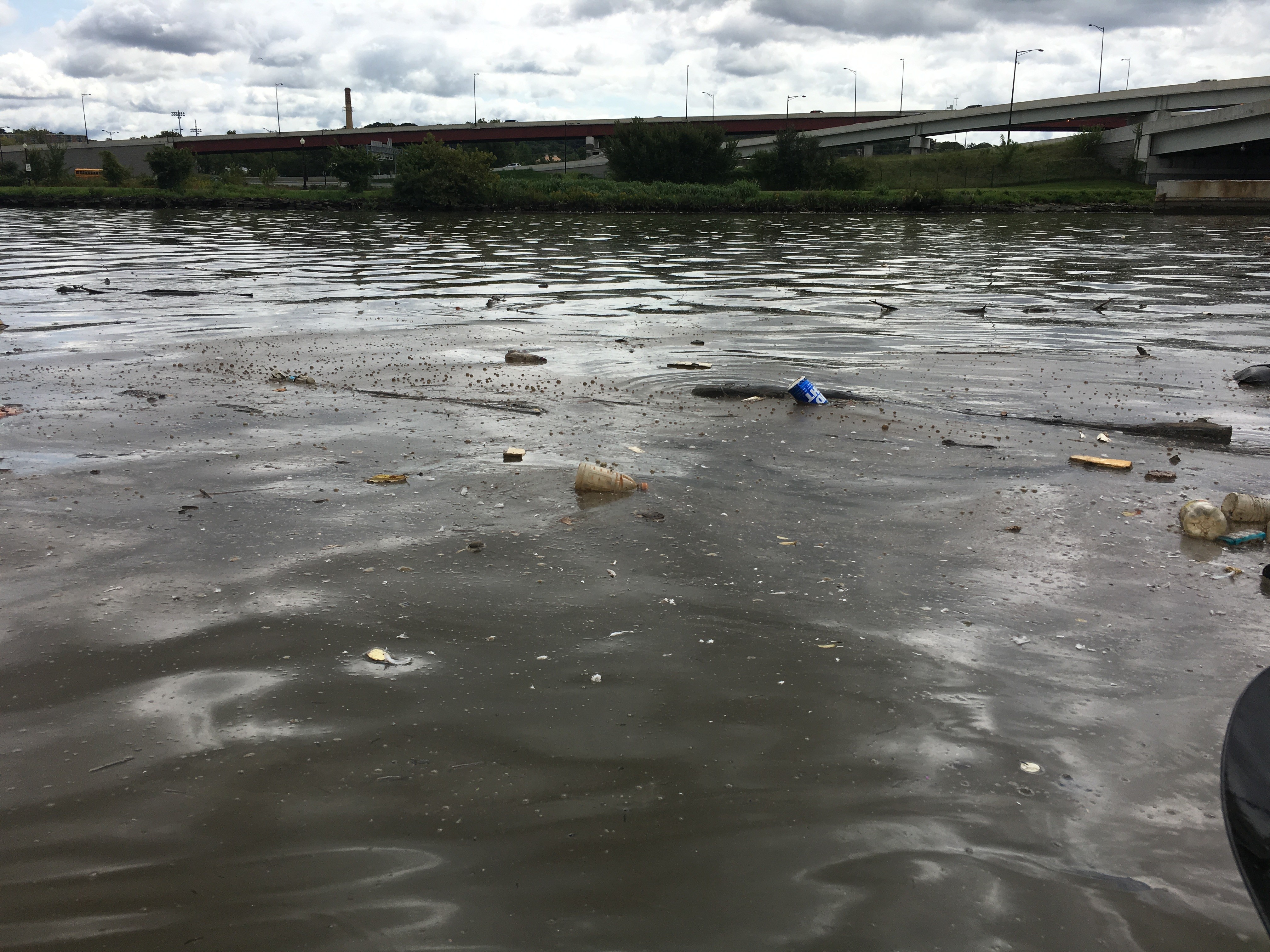 Plastic bottles, cups and other floating debris on the surface of the Anacostia River before the Anacostia River Tunnel began operating.
