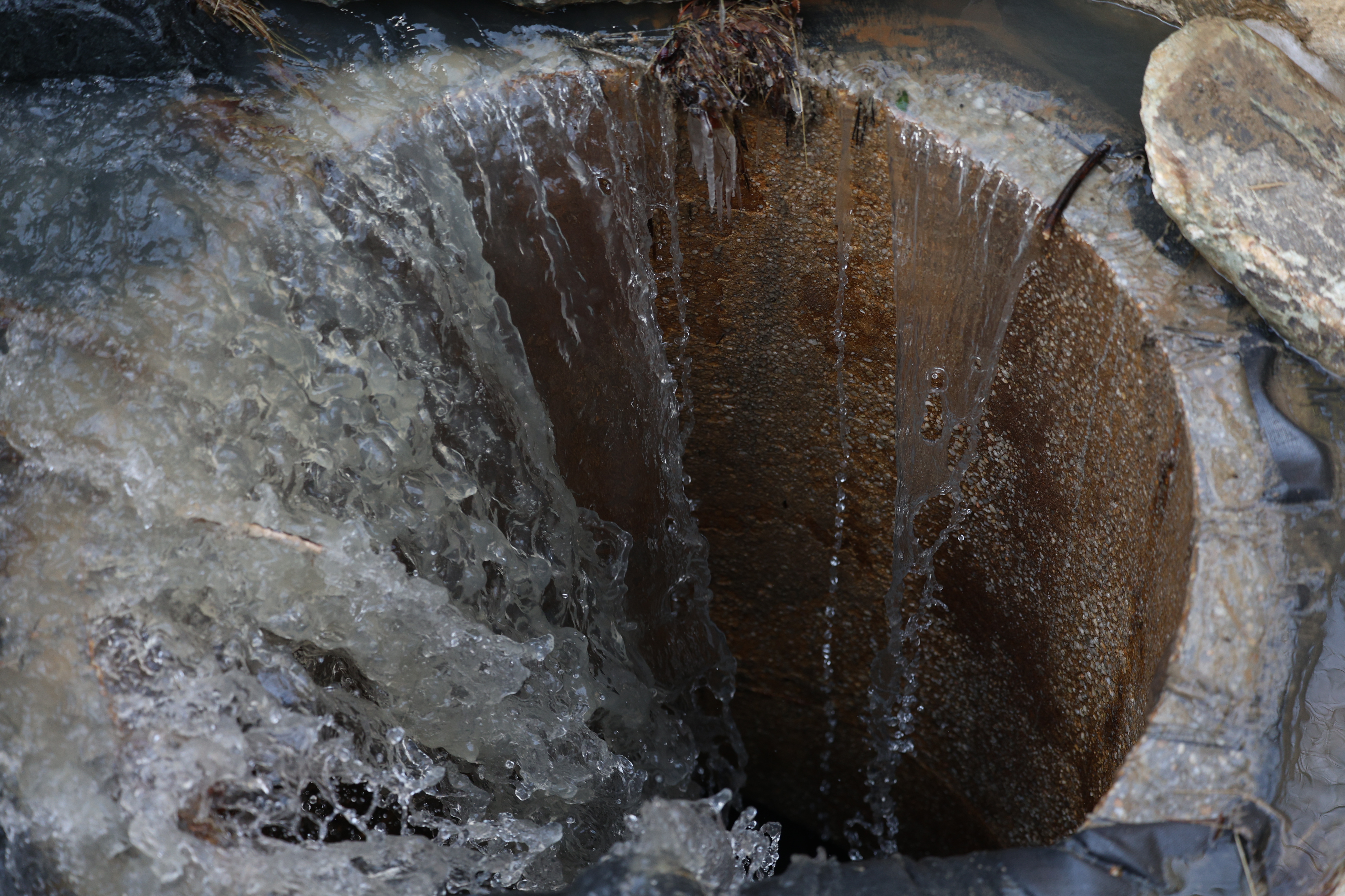 Photo of wastewater from the bypass going into the manhole downsteam for Potomac Interceptor