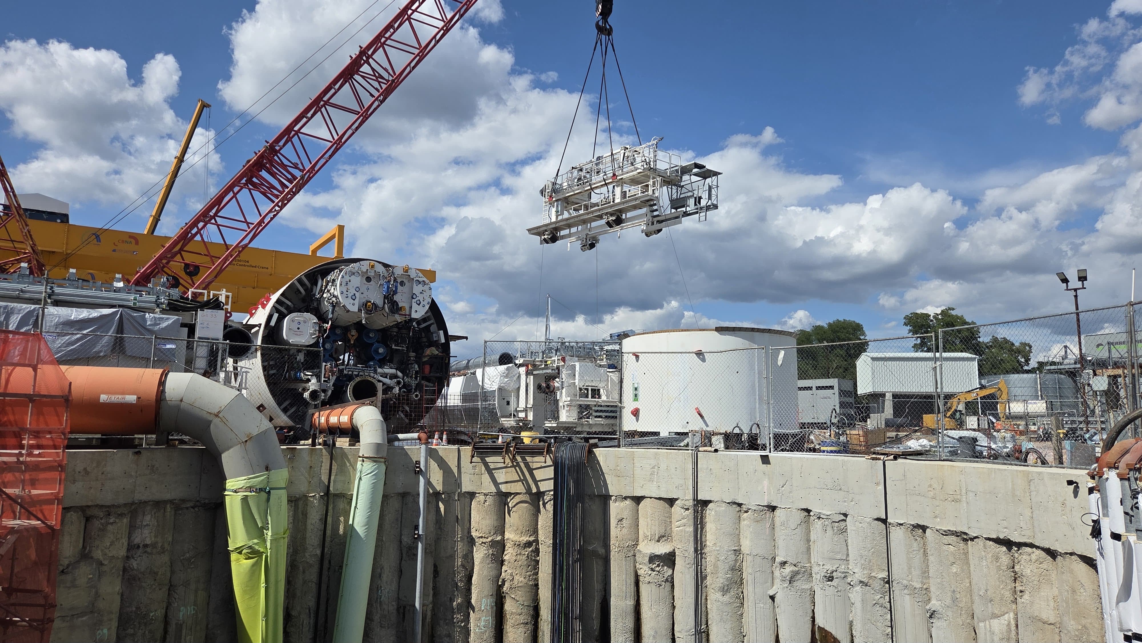 Mary's last gantry hanging from a crane as it is being lowered into the shaft