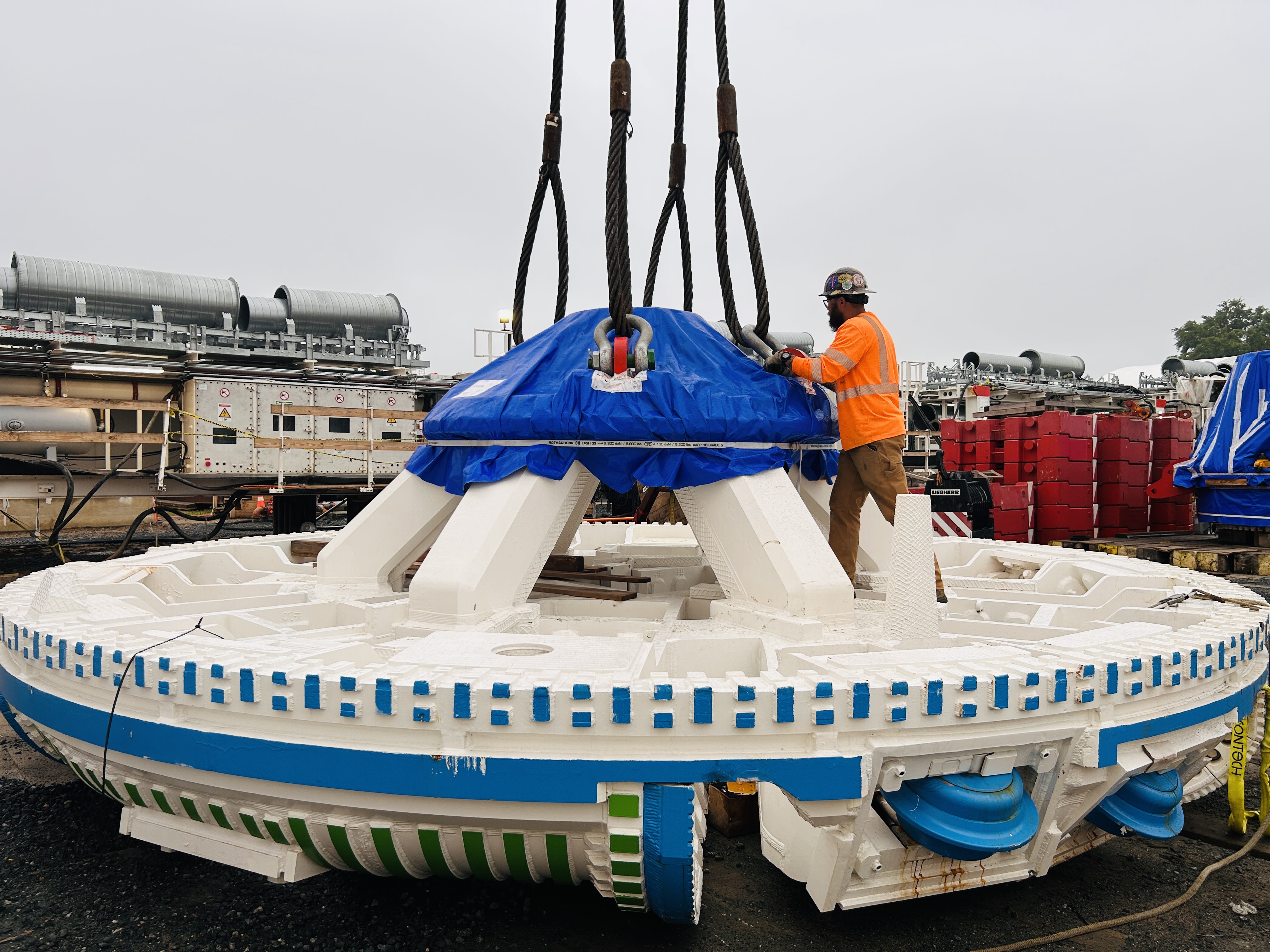 Worker removing the crane ties from the TBM cutterhead.