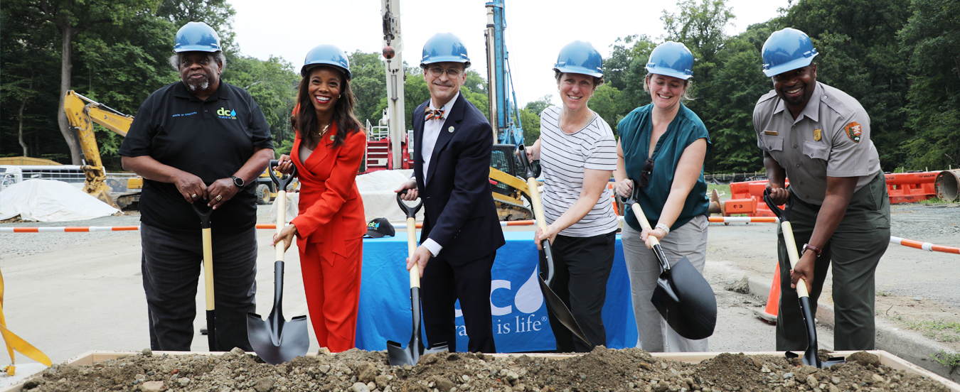 Officials holding shovels pause for a photo during the groundbreaking