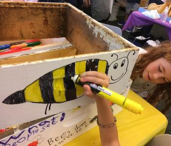 Photo of student drawing a bee