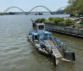 Skimmer Boat on the Anacostia River One of DC Water's skimmer boats on the Anacostia River with the Frederick Douglass Bridge in the background.