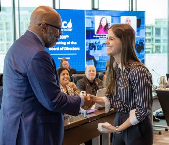DC Water General Manager and CEO David Gadis recognizes Lily MacDonald during the May Board of Directors meeting.