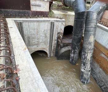 Image of new pipe section with wastewater flowing