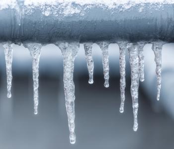 Picture of frozen water pipes with icicles hanging off of them