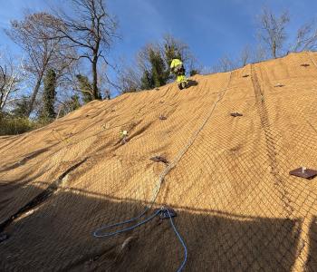Worker on side of steep slope