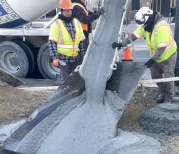 Photo of concrete being poured through a manhole or access point