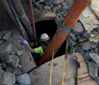photo of worker going into downstream cleaning pit 