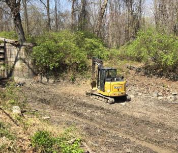 Soil Removal Underway with Excavator in Canal