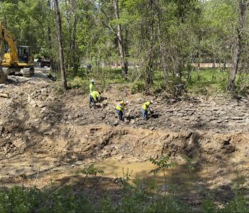 crews removing soil in C & O Canal 