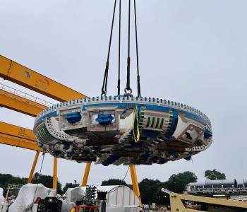Close-up of the TBM cutterhead suspended by a crane