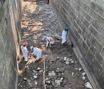 Workers clearing impacted soil from Lock 10