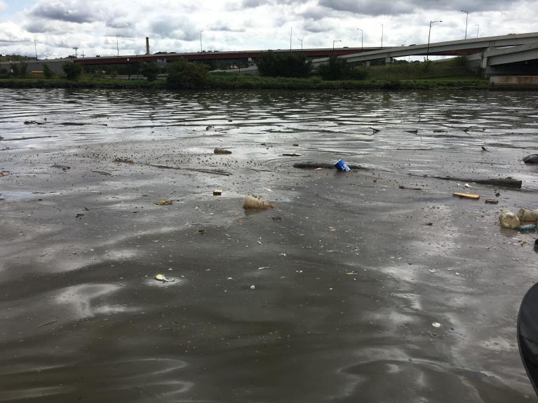 Plastic bottles, cups and other floating debris on the surface of the Anacostia River before the Anacostia River Tunnel began operating.