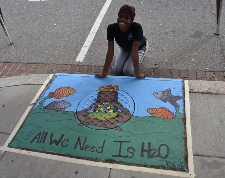 Artist and storm drain painting