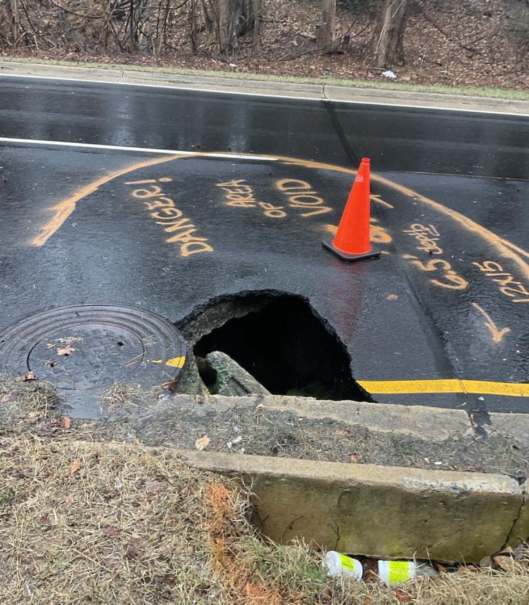 Suitland Pkwy Failed Stormwater Main and Sinkhole Photo of sinkhole on Suitland Parkway with hole in the road.