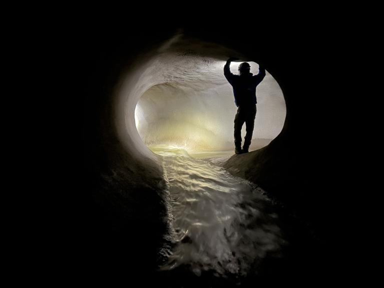 Phase 1 repair photo of tunnel and worker inside after completion