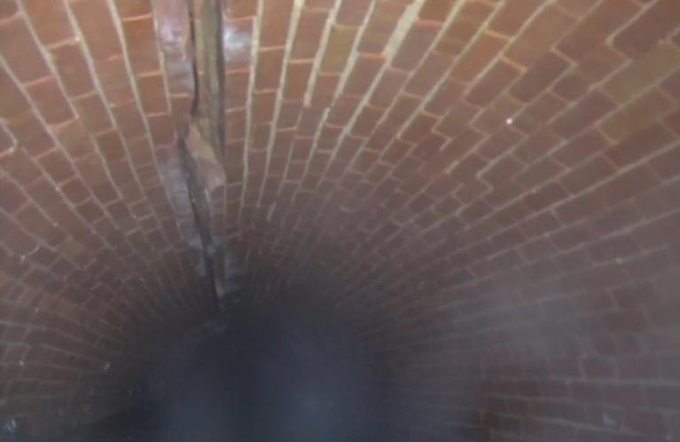 Picture showing inside of Rock Creek Main Interceptor with large crack in crown