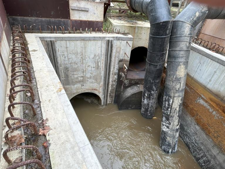 Image of new pipe section with wastewater flowing