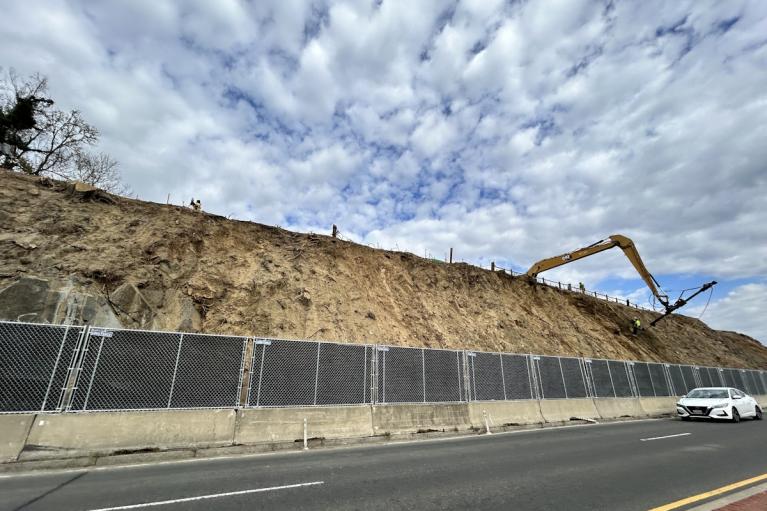 Image: A long arm machine drilling anchor bolts into the slope.