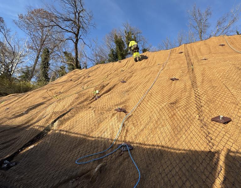 Worker on side of steep slope
