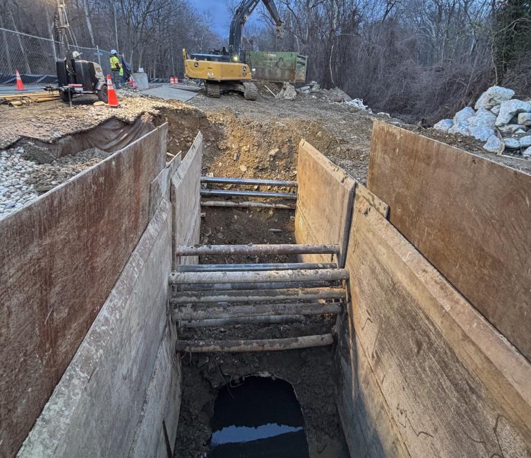 Photo of extended excavation site with trench boxes
