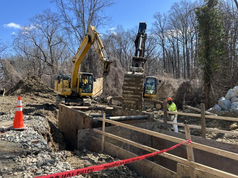 Trench box being installed to expand excavated area