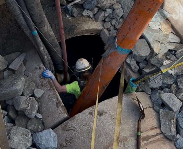 photo of worker going into downstream cleaning pit 