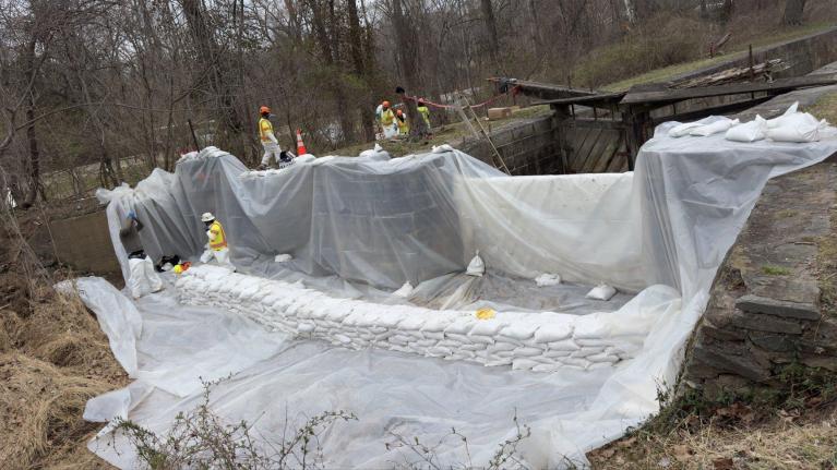 Workers constructing the freshwater dam to be used for flushing the C & O Canal