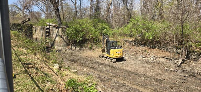 Soil Removal Underway with Excavator in Canal