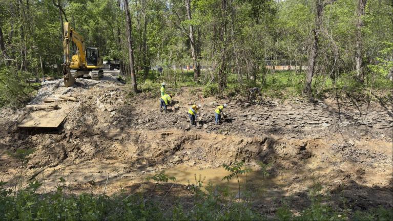 crews removing soil in C & O Canal 