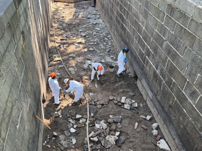 Workers clearing impacted soil from Lock 10