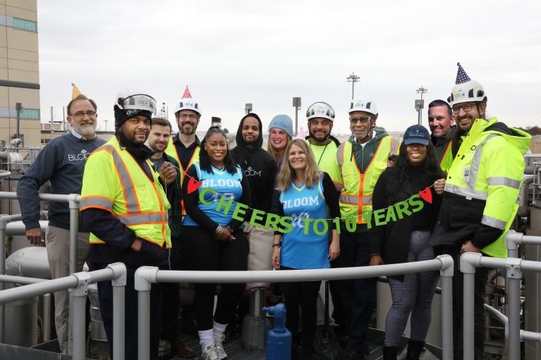 Photo of Bloom and Blue Drop staff celebrating 10 years of Bloom at Blue Plains