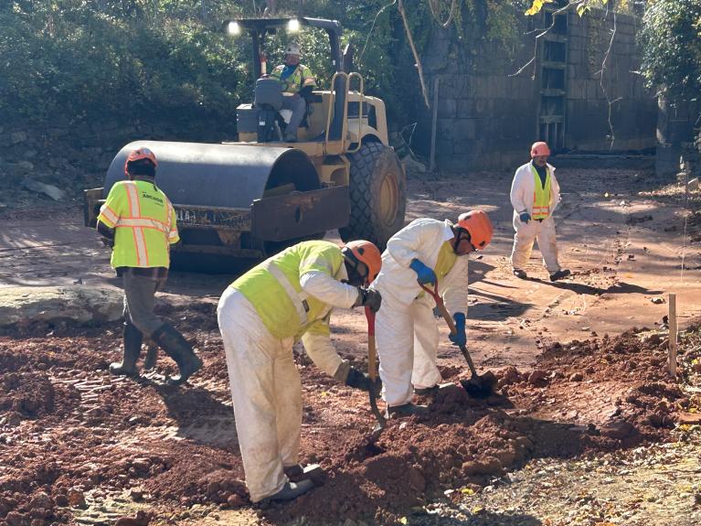 Compact Roller and workers working on the C & O Canal clay liner