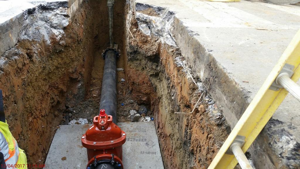 Cast-iron water main in trench.
