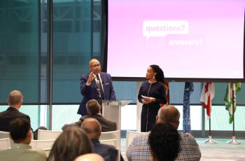 Photo of CEO David Gadis and Chief Communications and Stakeholder Engagement Officer Kirsten Williams addressing the audience at a town hall meeting.