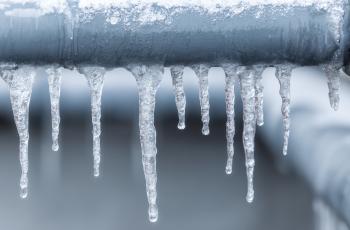 Picture of frozen water pipes with icicles hanging off of them
