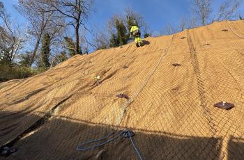 Worker on side of steep slope