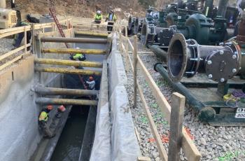 Photo of access pit upstream with four pumps lined up ready for installation
