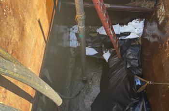 Potomac Interceptor Access Point showing sewer line where vacuum hoses are going in to clear debris