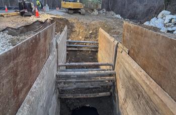 Photo of extended excavation site with trench boxes