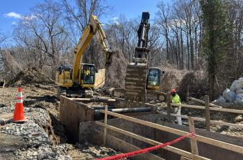 Trench box being installed to expand excavated area