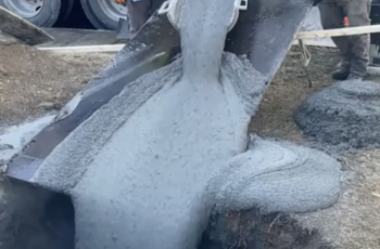 Photo of concrete being poured through a manhole or access point
