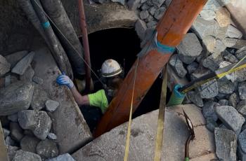 photo of worker going into downstream cleaning pit 