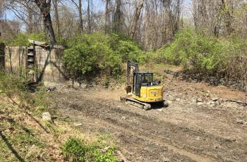 Soil Removal Underway with Excavator in Canal
