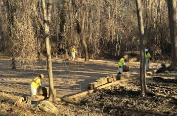 Workers putting down rye and matting for soil stabilization