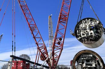 The shields for the tunnel boring machine Mary being lowered by cranes into the shaft