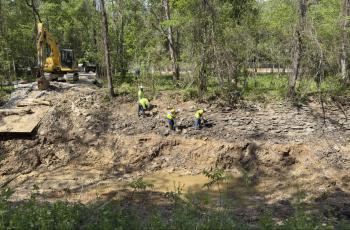 crews removing soil in C & O Canal 