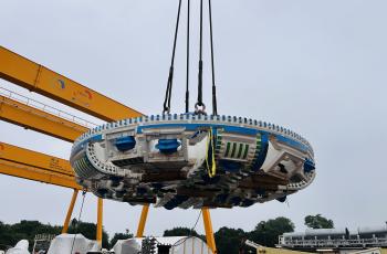 Close-up of the TBM cutterhead suspended by a crane