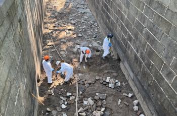 Workers clearing impacted soil from Lock 10